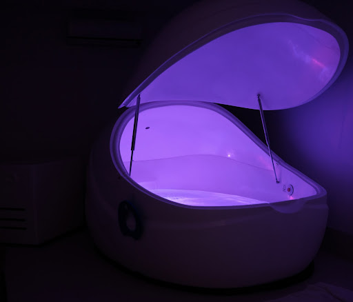 Purple flotation tank in a dark room