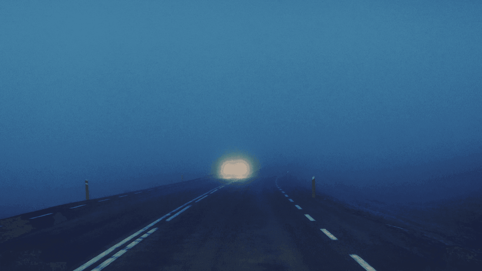 Blurred headlights on the road at night in Iceland