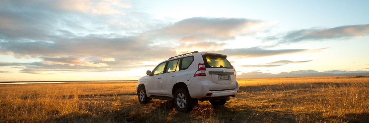 Toyota Landcruiser in a field in Iceland at sunset