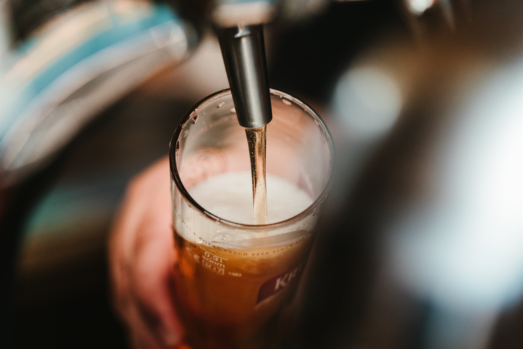 Beer pouring into a pint glass in a street food hall