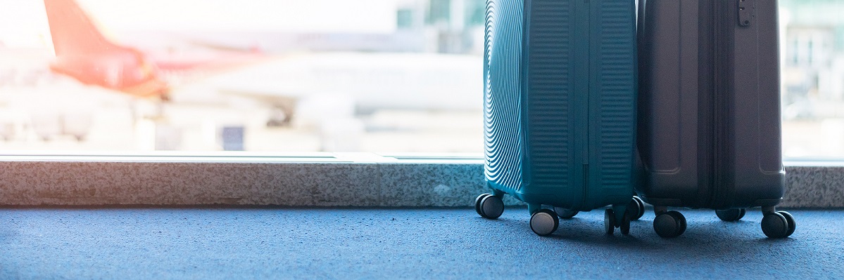 Suitcases in the airport near a window