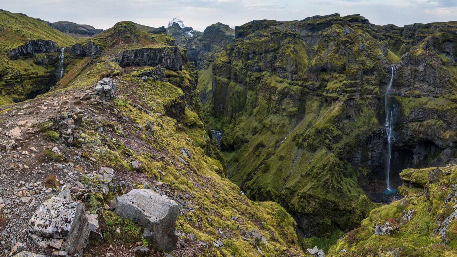 Múlagljúfur Canyon in Iceland with two waterfalls in the distance.