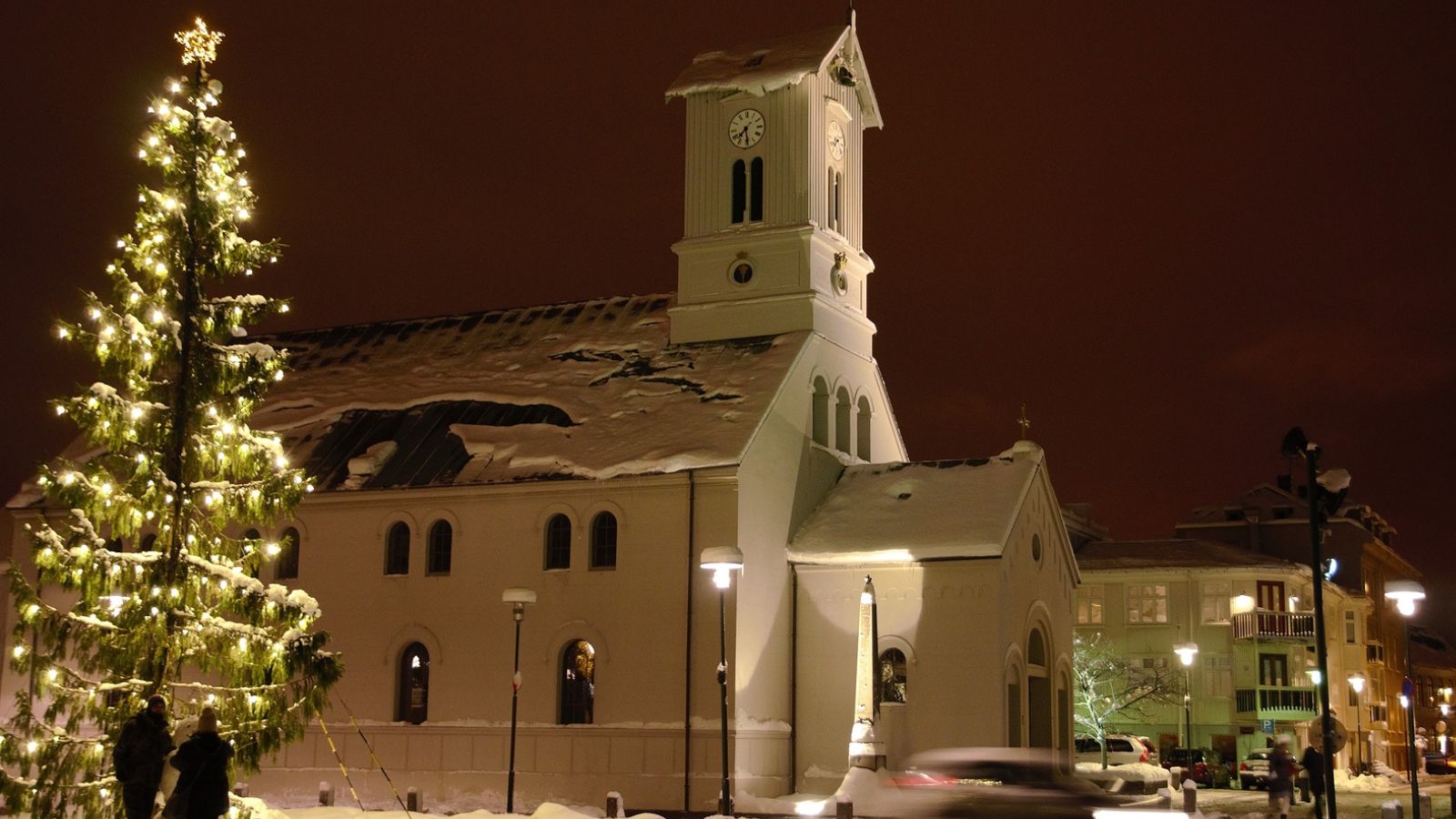 A church and Christmas tree at Christmas in Iceland. 