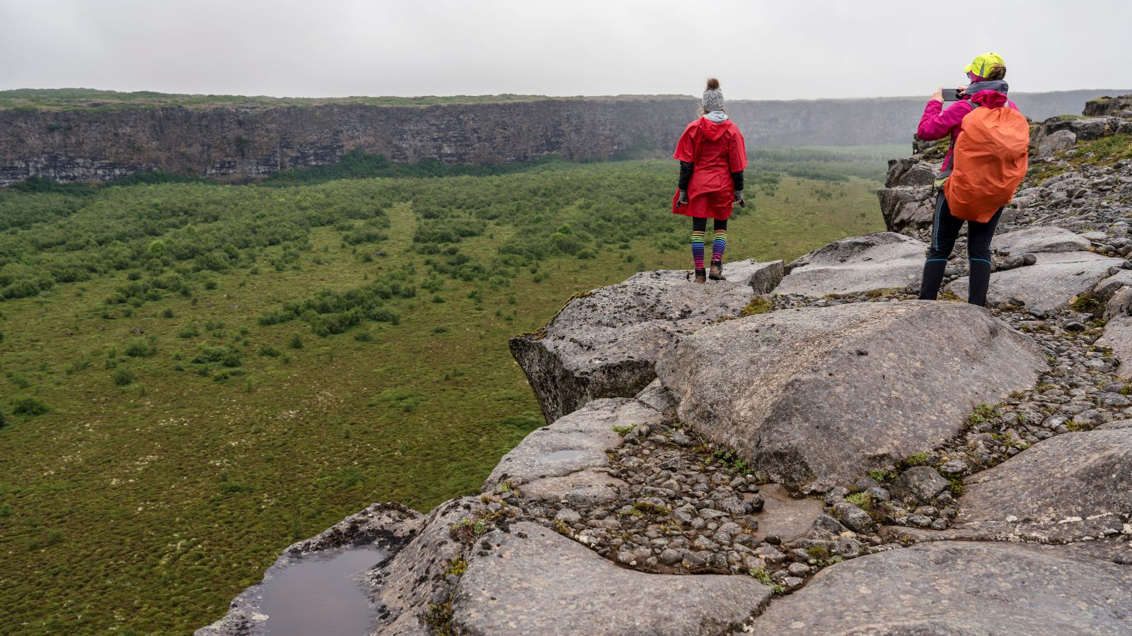  Tourists looking over Ásbyrgi Canyon in Iceland.