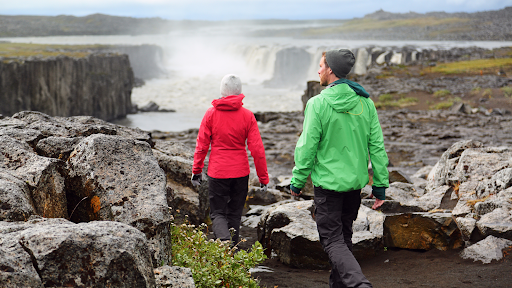 Couple walking near a waterfall in Iceland