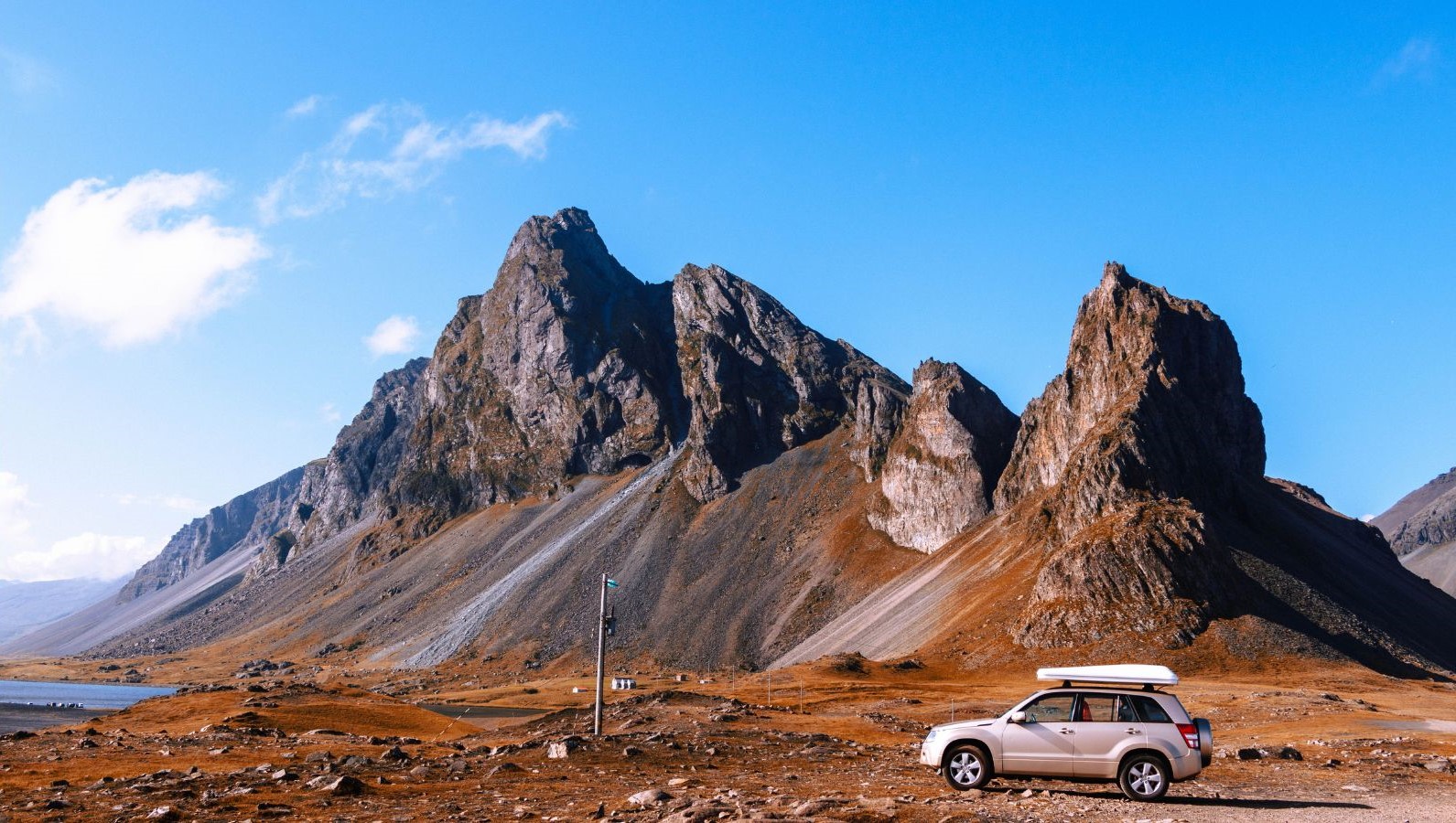 Car in front of Vestrahorn Mountain in Iceland.