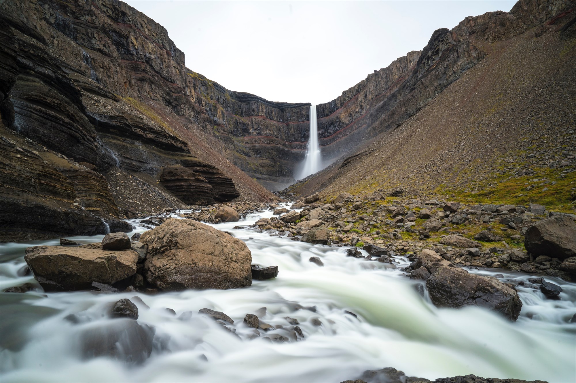 Small waterfall with water splashing and tumbling over the rocks