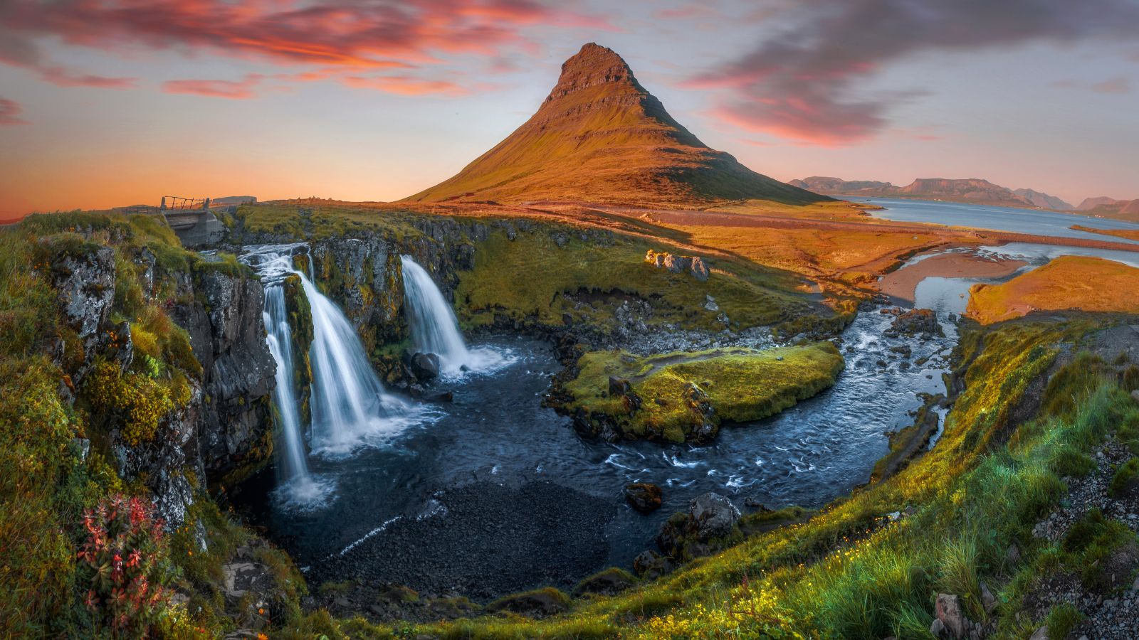 Mount Kirkjufell and waterfall against the sunset in Iceland.