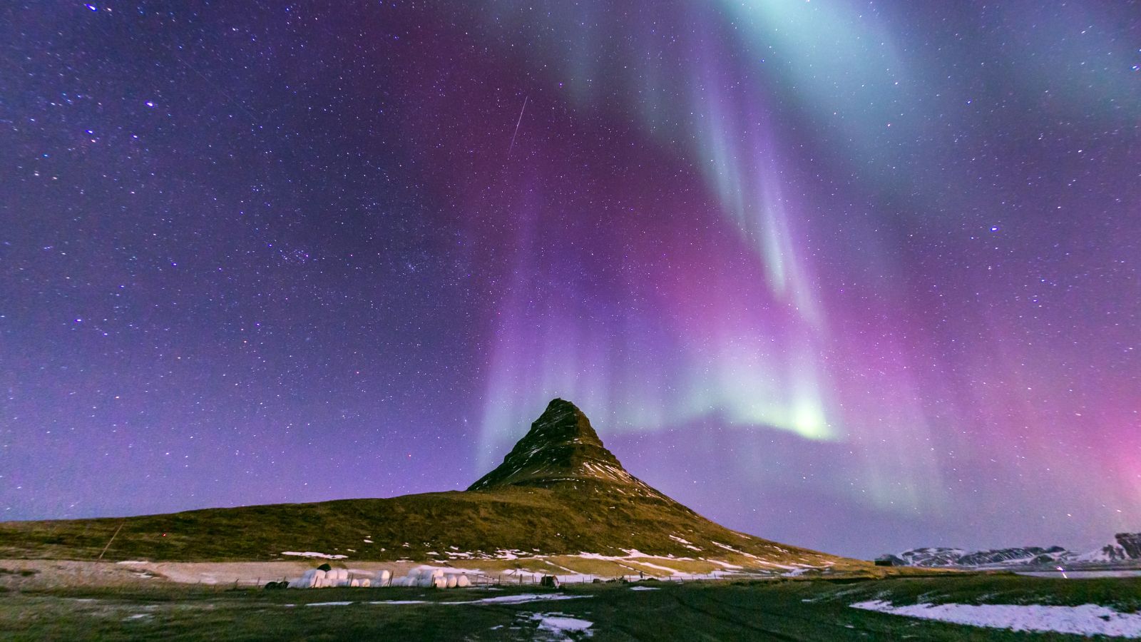 Mount Kirkjufell under the Northern Lights.