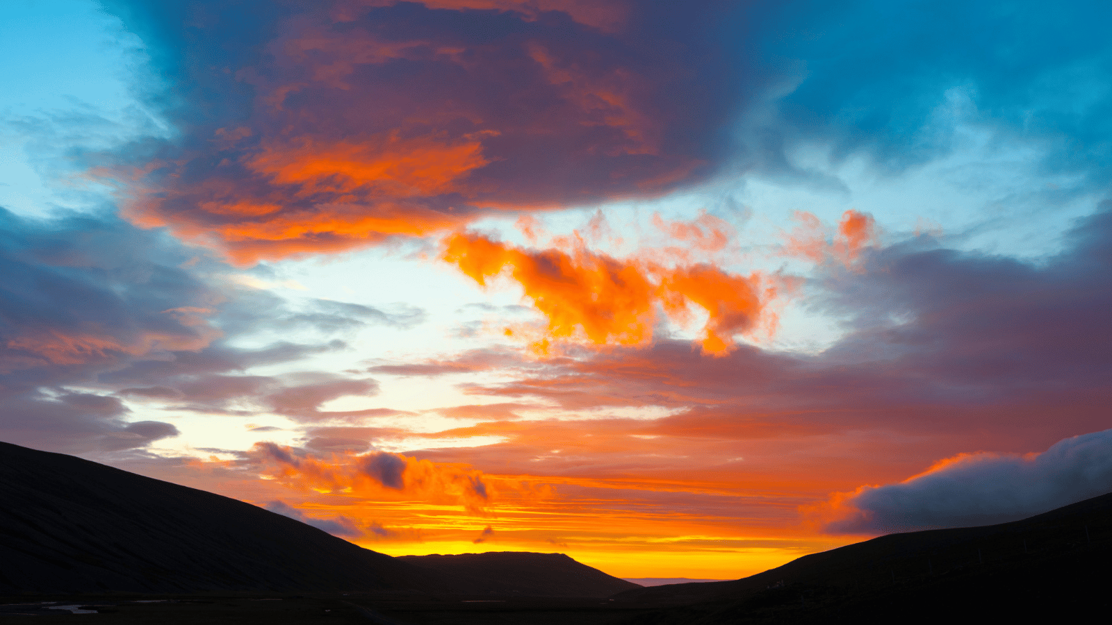 Colorful arctic clouds ahead of the midnight sun in Iceland.