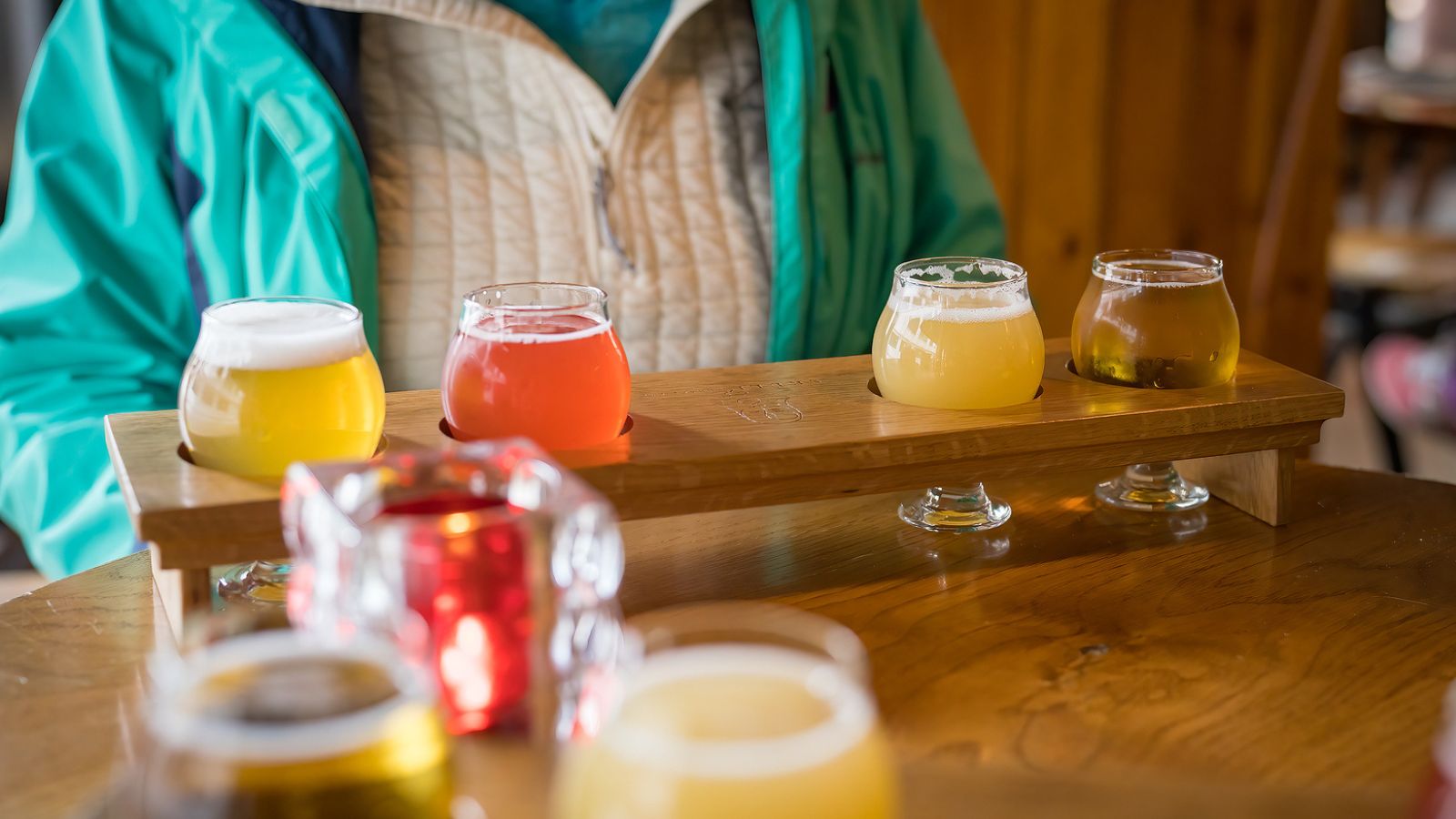 Person sampling a flight of craft beers at a bar in Iceland. 