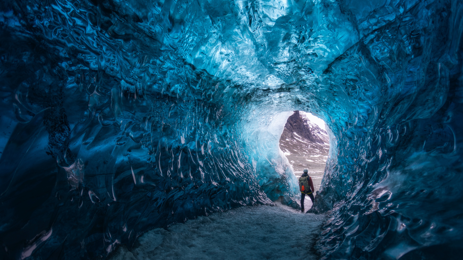 Man standing in an ice cave in Iceland.