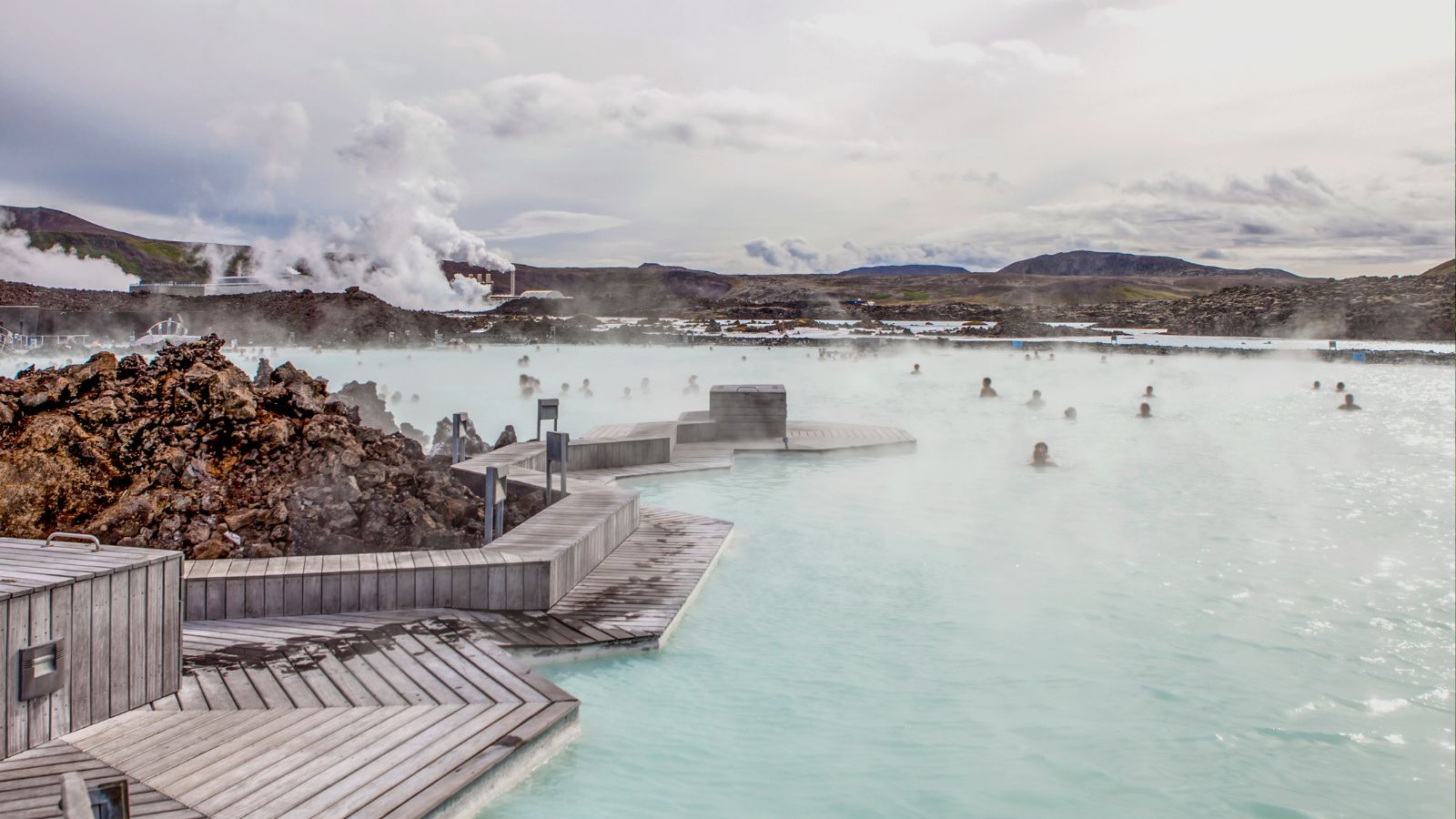 Visitors enjoying the geothermally heated waters at the Blue Lagoon, Iceland.