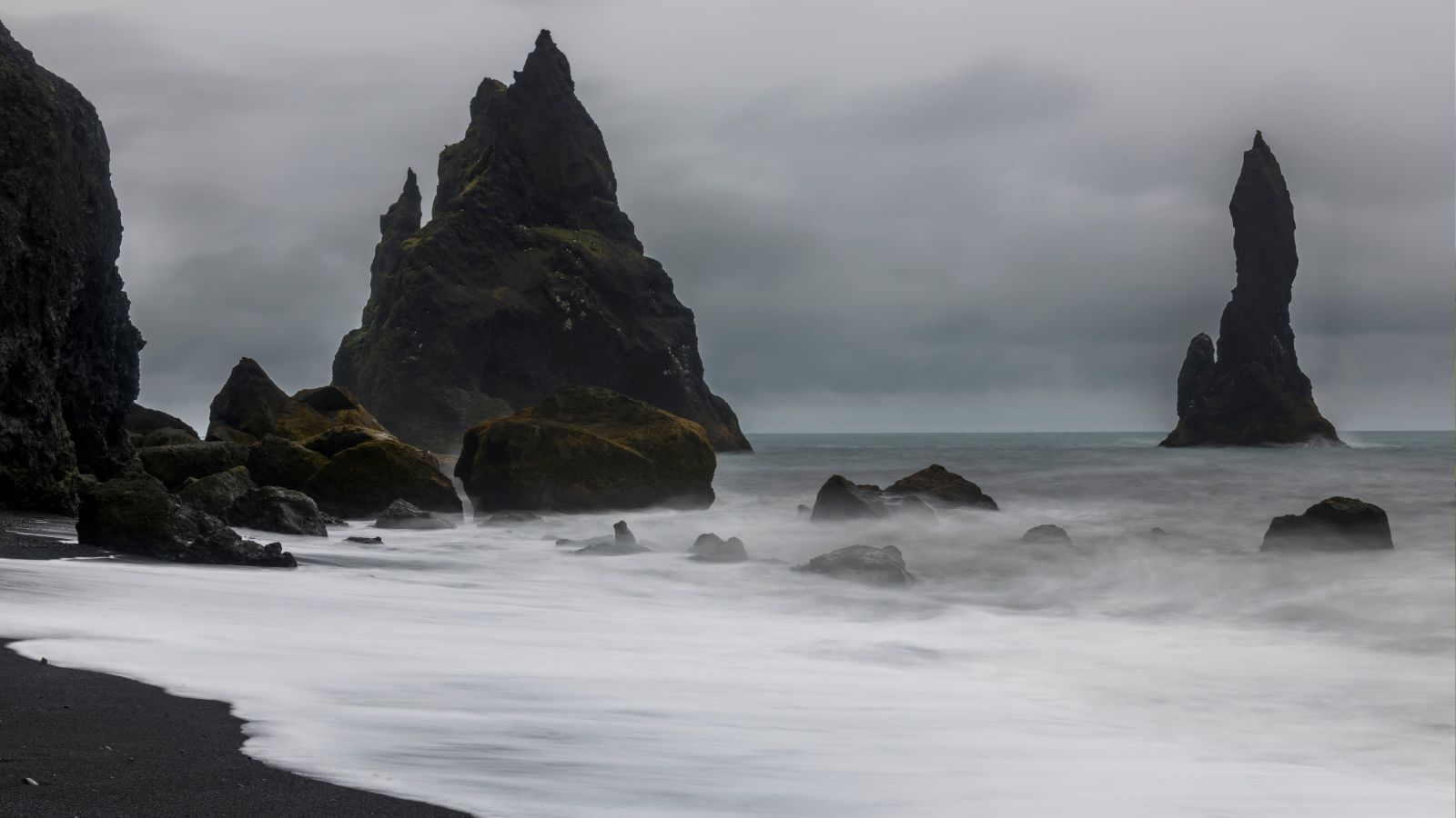Sea stacks in the mist at Reynisfjara Black Sand beach.