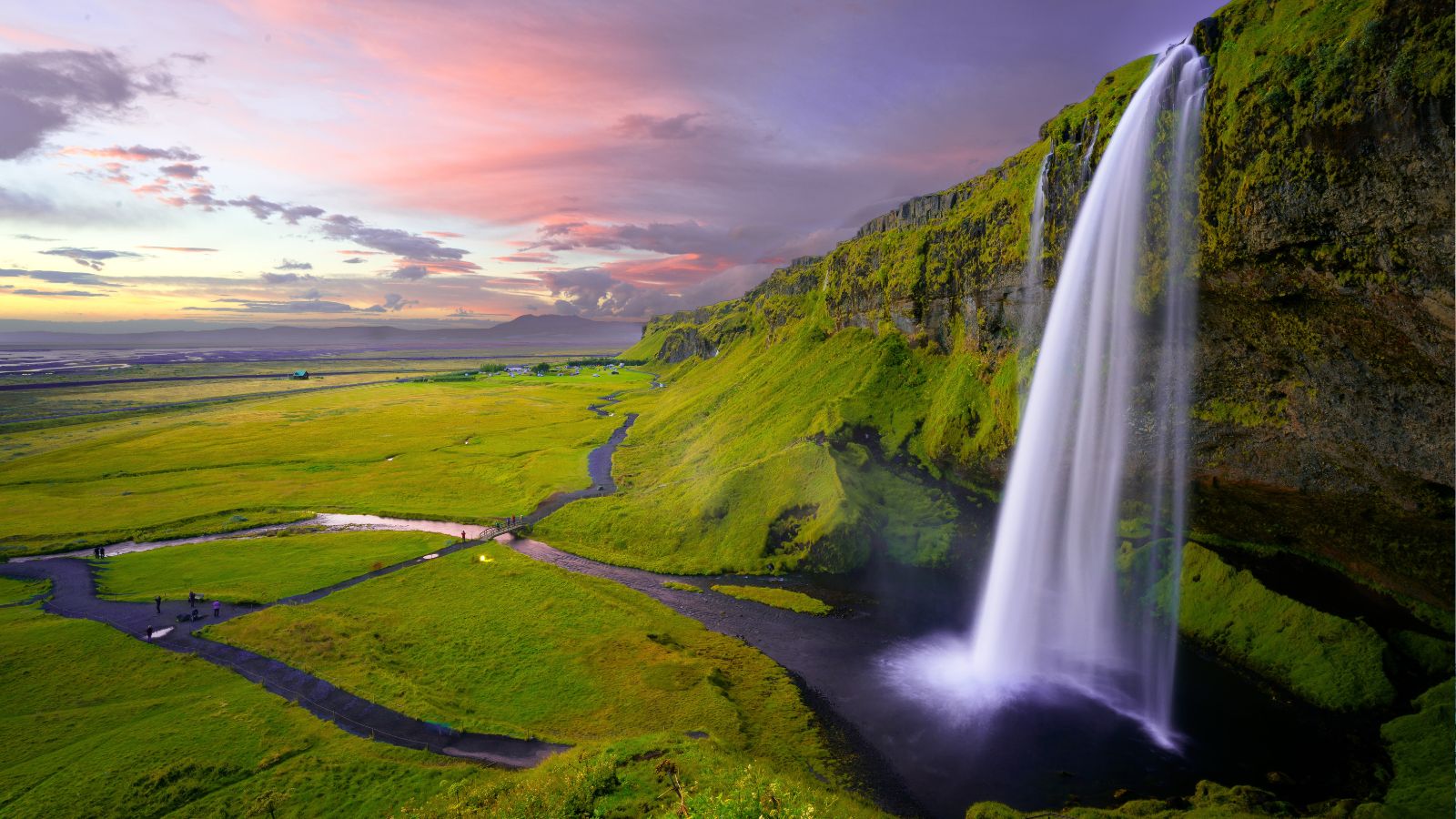 Seljalandsfoss waterfall in Iceland at sunset.