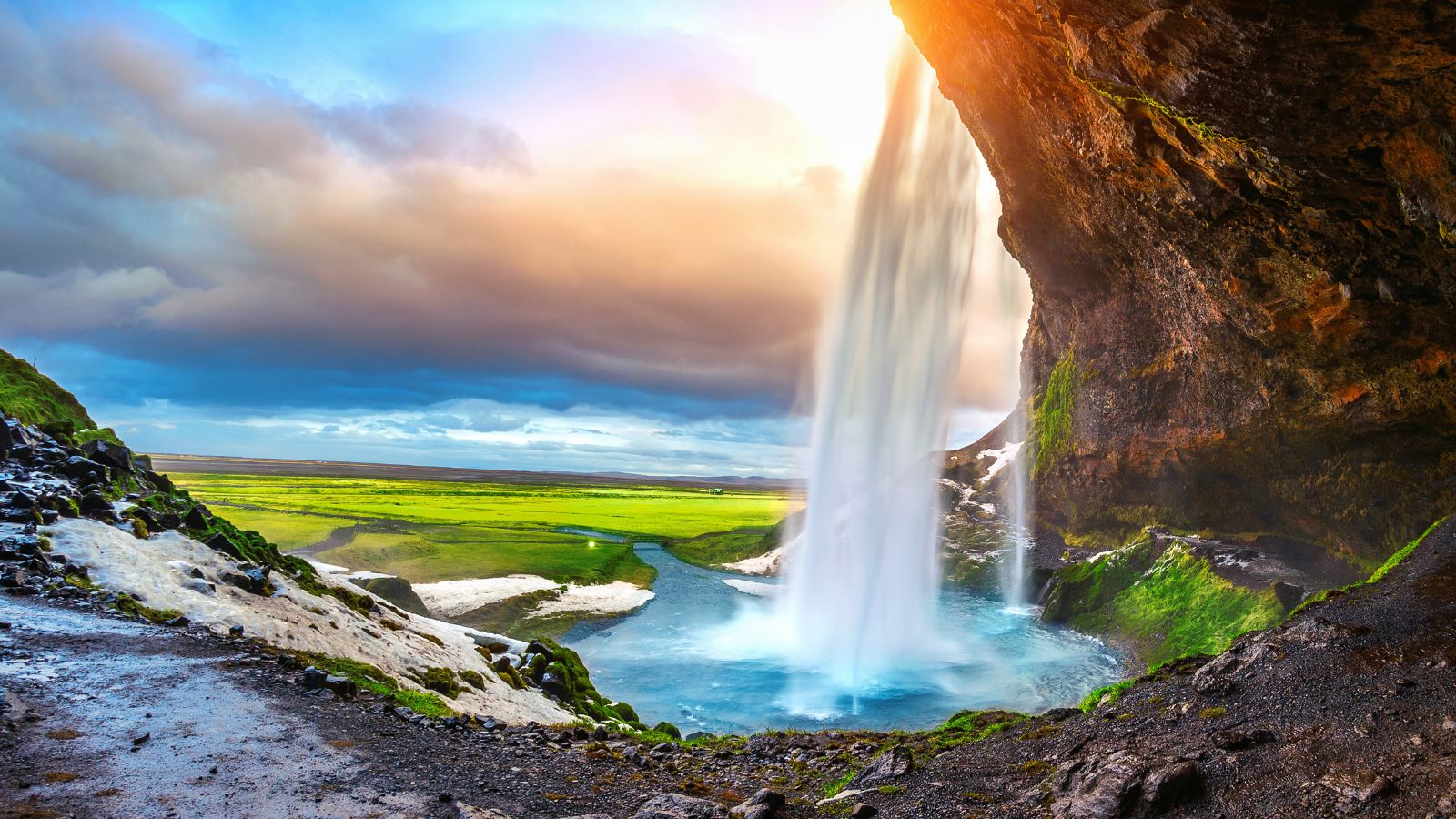 Seljalandsfoss in the winter with piles of snow.
