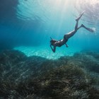 Woman snorkelling underwater.