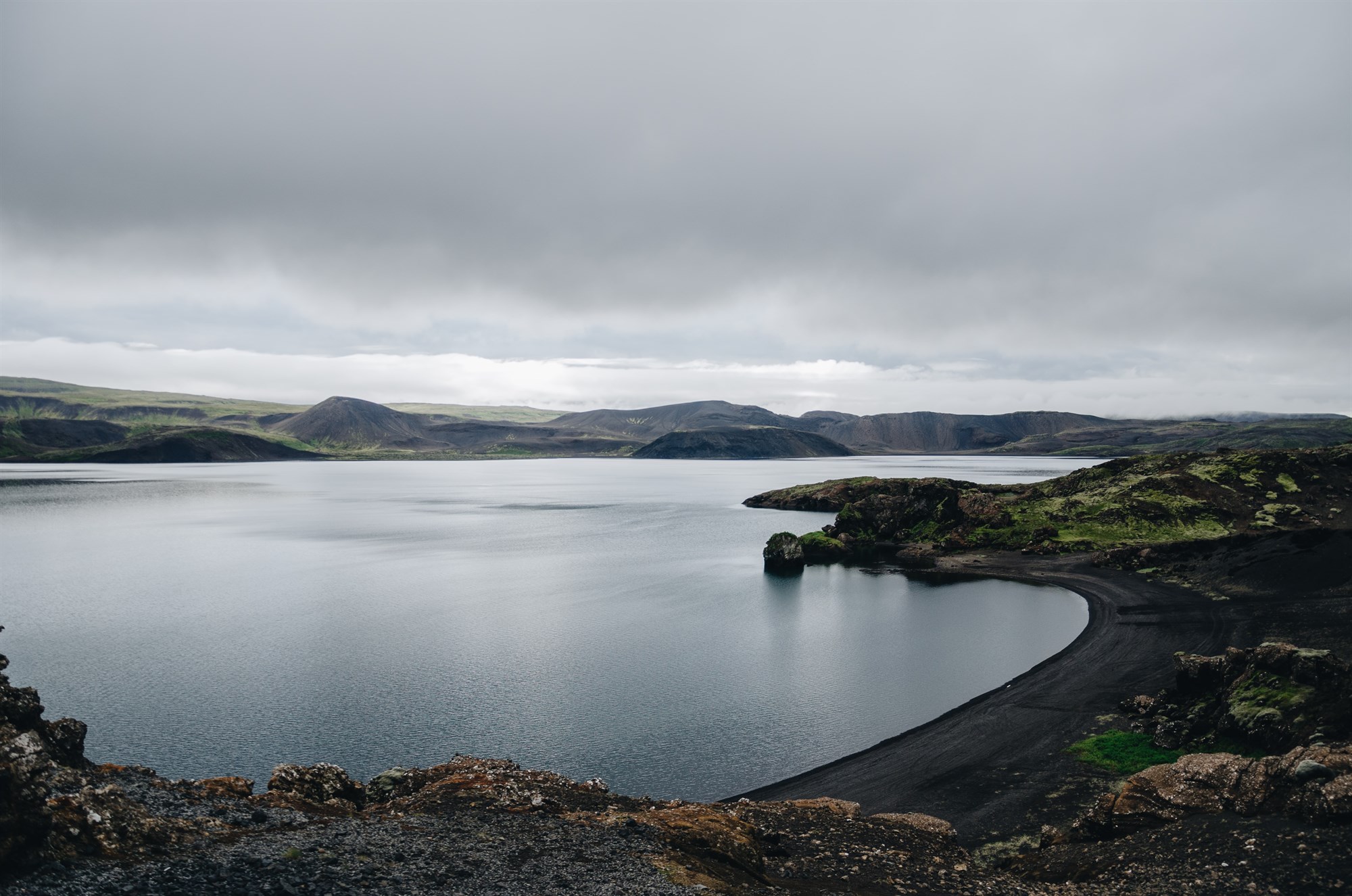 Rocky outcrops and black sand beach around Lake Kleifarvatn in Iceland.
