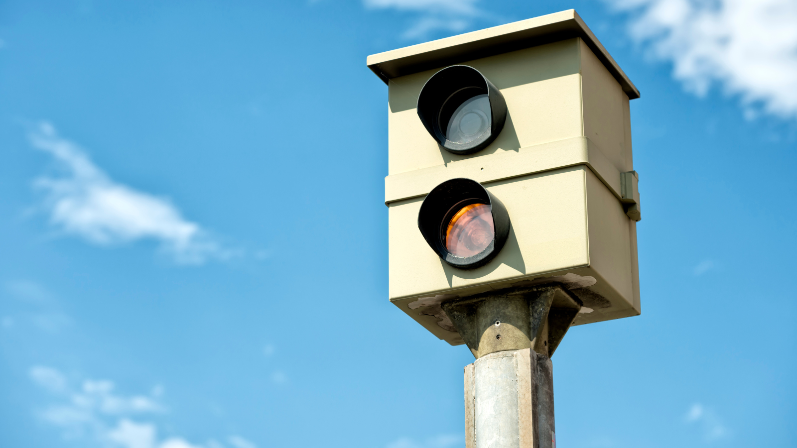 Speed camera against a blue sky.