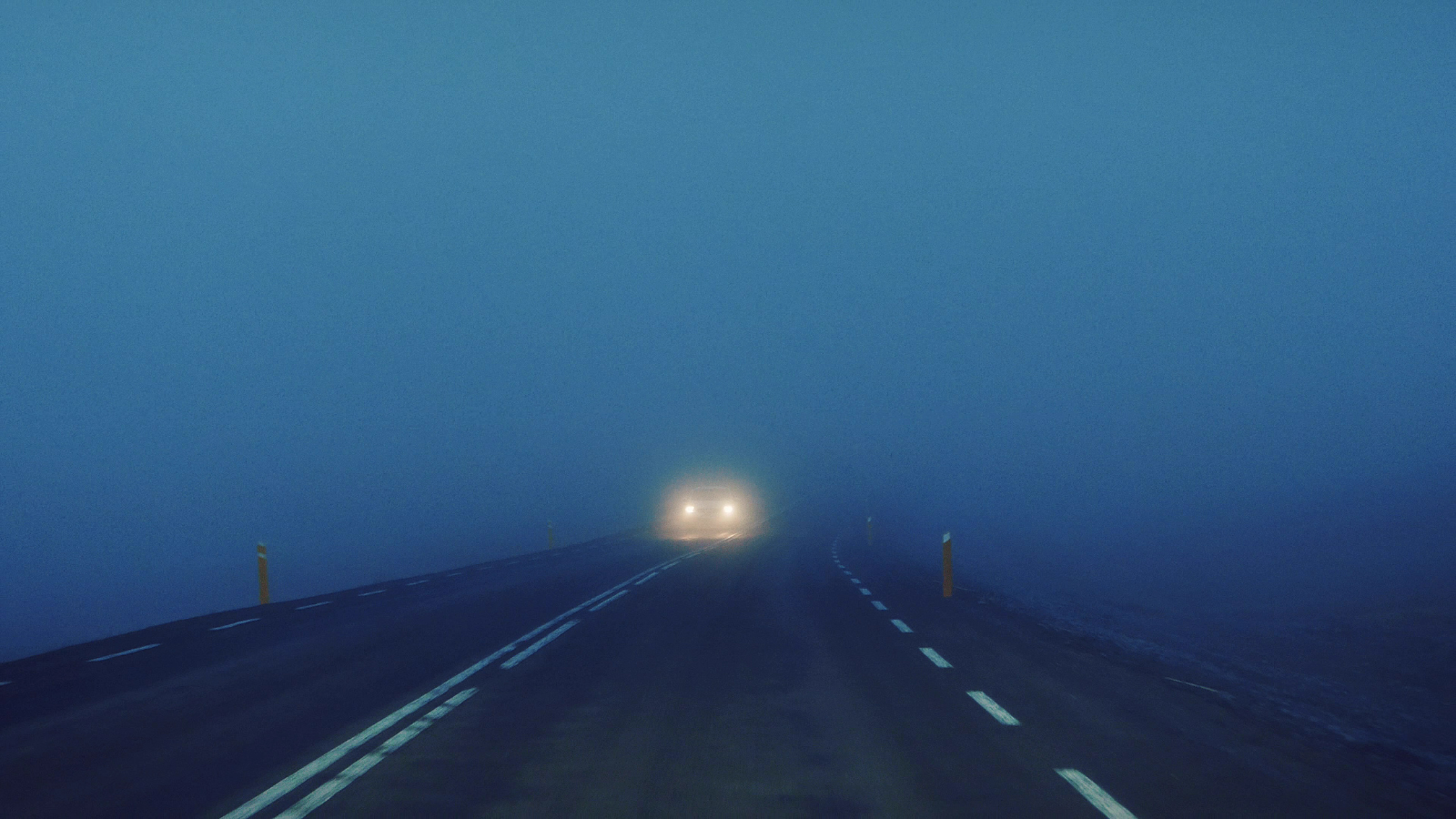 Blurred headlights on the road at night in Iceland