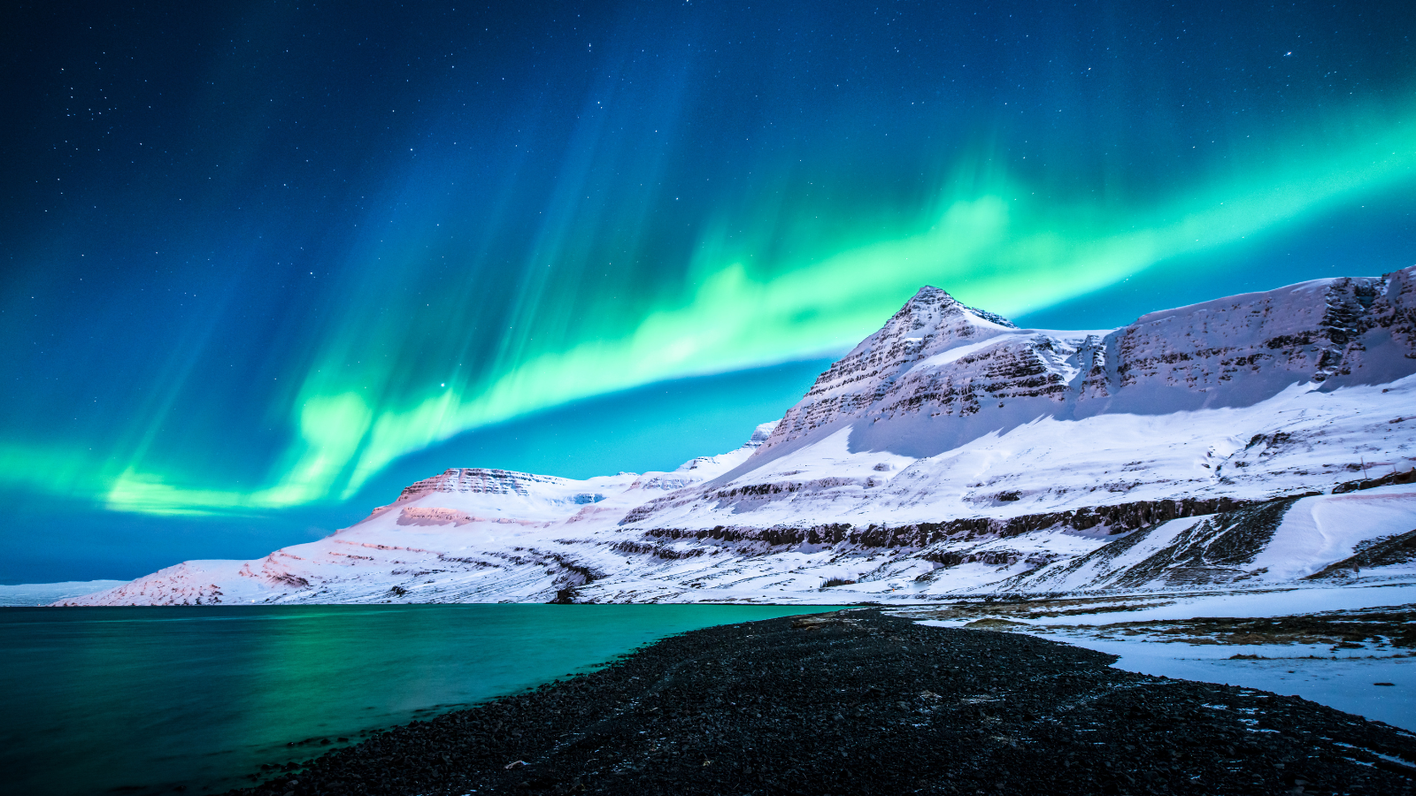 Northern Lights (aurora borealis) over Icelandic mountain
